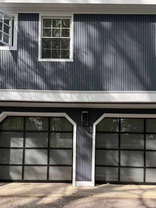 Modern house front with light gray composite cladding boards