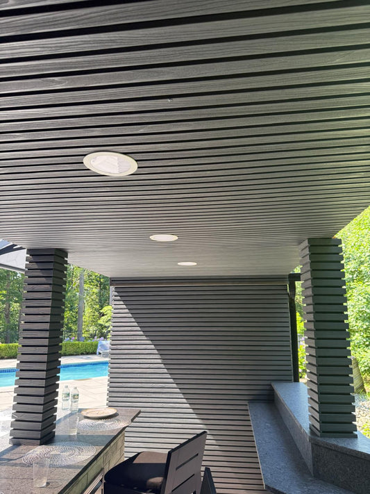 Black composite cladding boards framing a modern outdoor sitting area