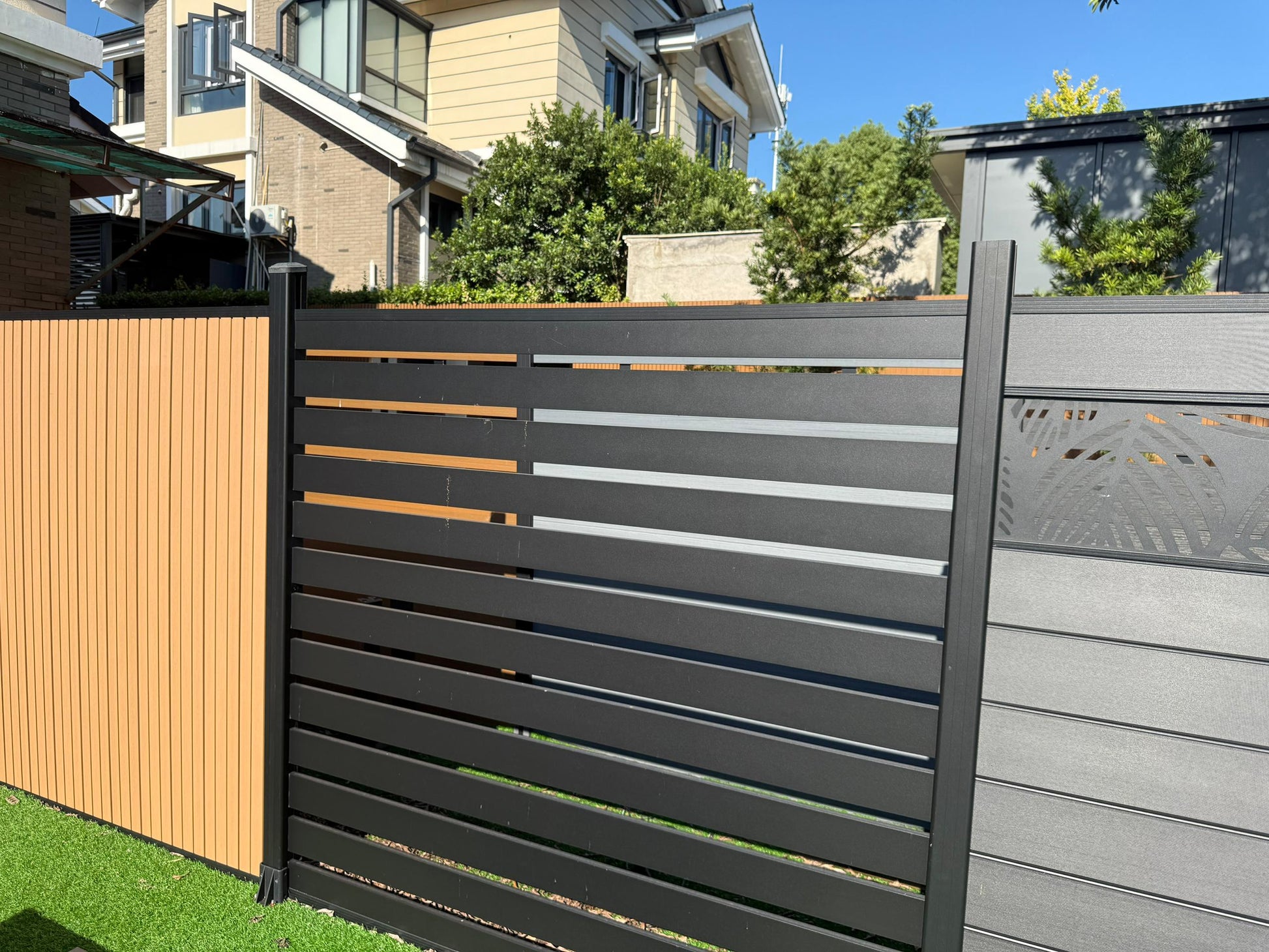 Modern fence design with horizontal slats in various colors.
