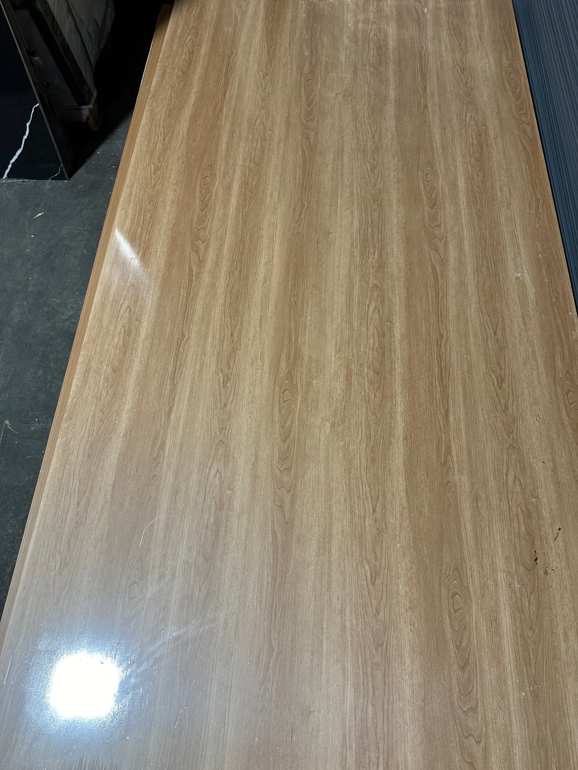 Smooth, high-gloss bamboo charcoal veneer panel with light brown wood grain and dark knots, fireproof & waterproof for NJ