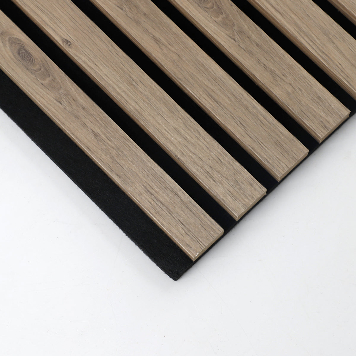 Corner detail of white acoustic wood slats with finished edges on black backing