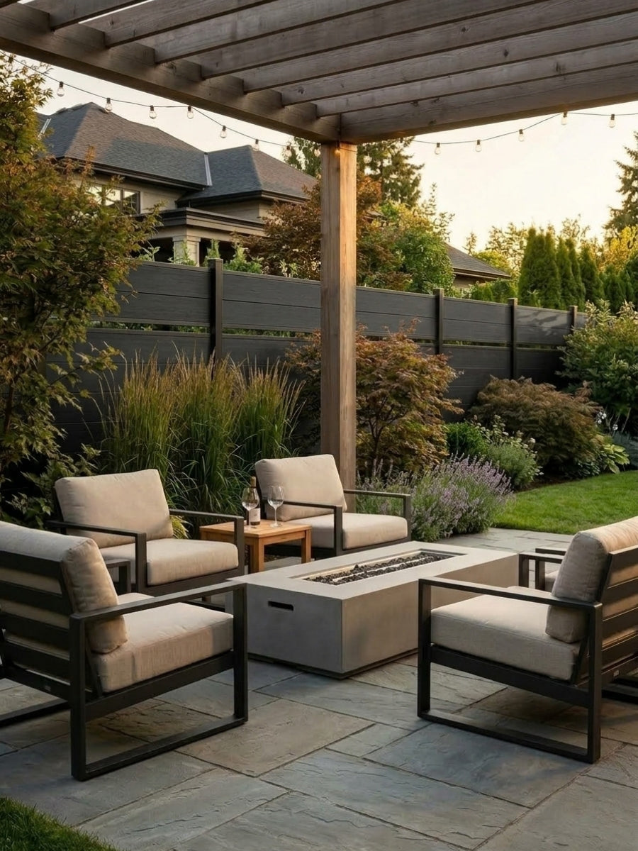 Black single divider composite fence behind a covered patio seating area with a fire table