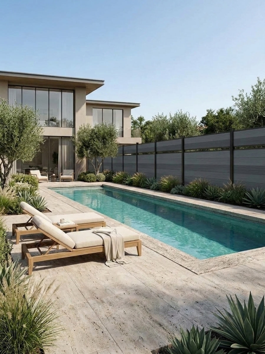 Light gray single divider composite fence enclosing a modern backyard swimming pool and sun deck