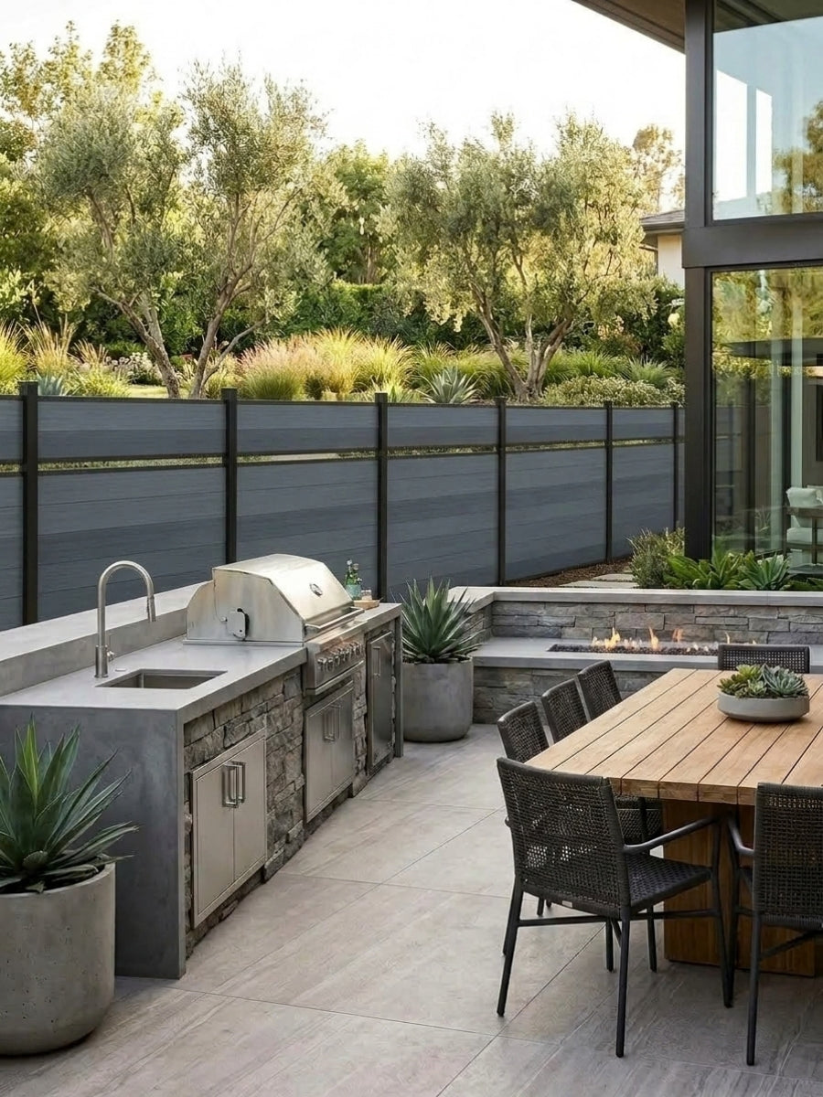 Light gray single divider composite fence surrounding a modern outdoor kitchen and dining patio