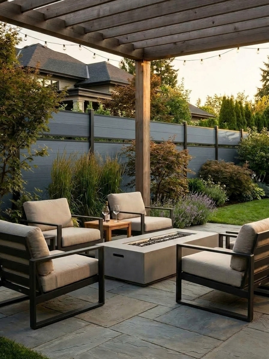 Light gray single divider composite fence behind a covered garden seating area with fire table