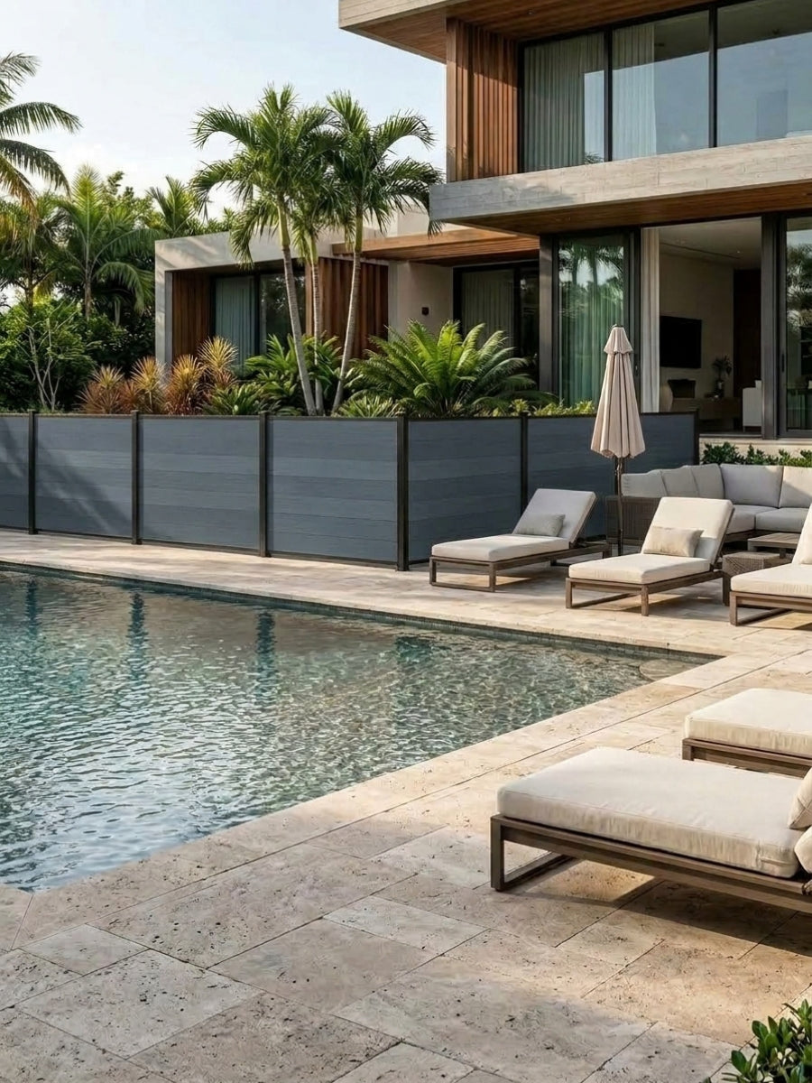 Light gray composite privacy fence panels installed beside a modern backyard swimming pool