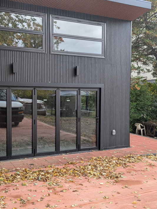 Close-up of black composite cladding texture, wide boards