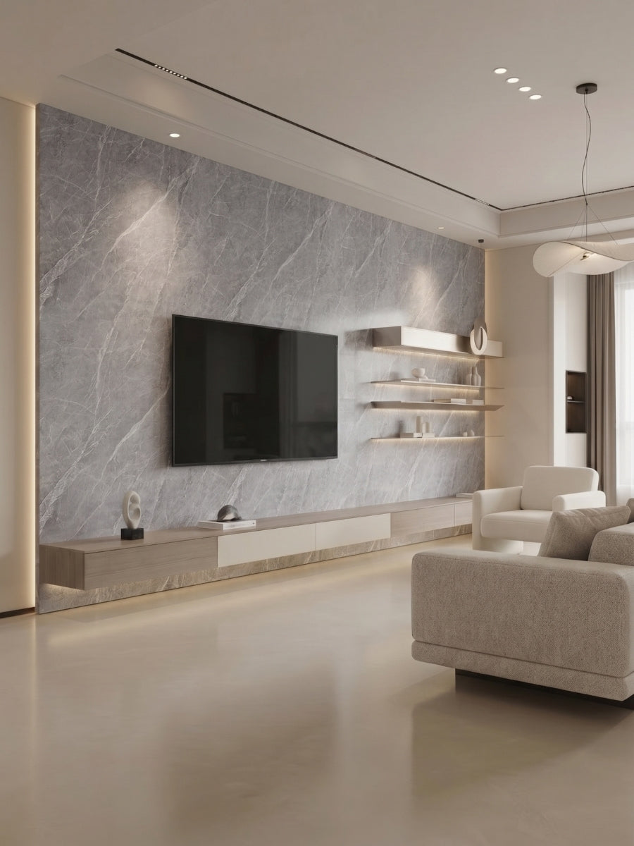 Modern living room with an ash gray marble-look PVC feature wall, mounted TV, floating shelves, and neutral seating.